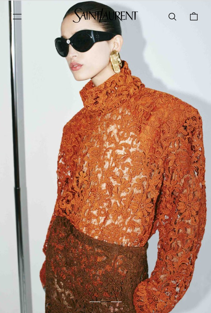 A model wearing a structured lace bodysuit in burnt orange paired with a chocolate lace pencil skirt and oversized black sunglasses.